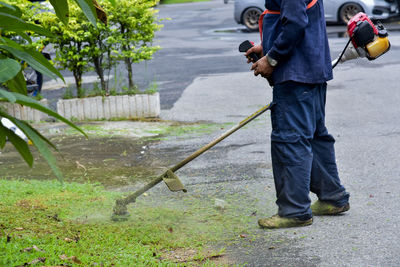 Low section of man working on road