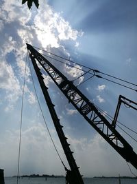 Low angle view of silhouette bridge against sky