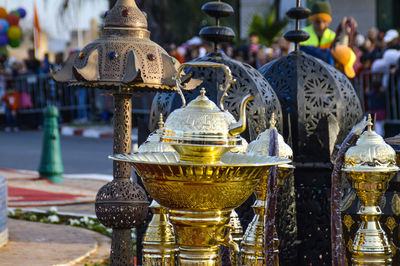 Close-up of metal bell outside temple against building