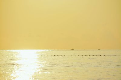 Scenic view of sea against clear sky during sunset