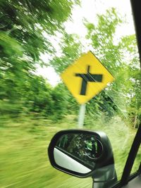 Close-up of road sign against trees