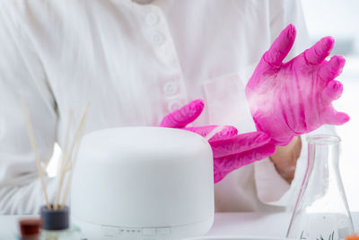 Perfumer or scientist smelling fragrance from humidifier, testing it.