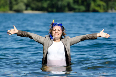 Portrait of smiling woman standing in lake