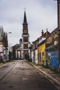 Street amidst buildings against sky in city