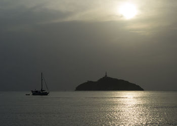 Sailboat sailing on sea against sky