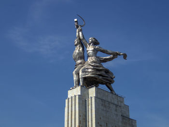 Low angle view of statue against blue sky