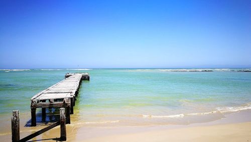 Scenic view of sea against clear blue sky