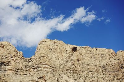 Low angle view of rock formations against sky