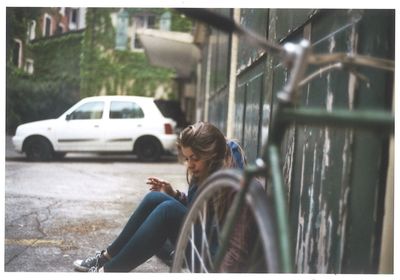 Side view of young woman using mobile phone