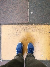 Low section of man standing on footpath