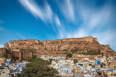 View of mehrangarh and the city of jodhpur against cloudy sky