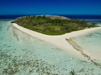 Scenic view of beach against blue sky