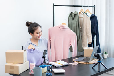 Side view of woman using laptop on table
