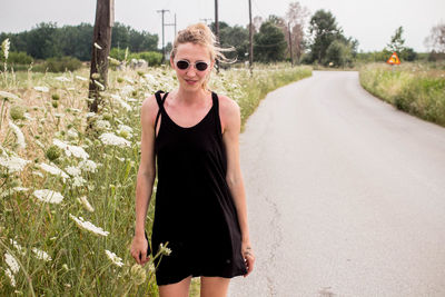 Portrait of smiling young woman on road