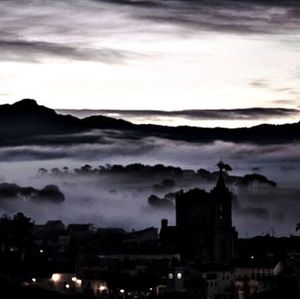 Cityscape against cloudy sky