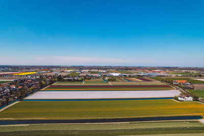 High angle view of field against clear blue sky