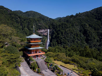 Scenic view of trees and mountains against clear sky