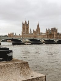 Bridge over river with city in background