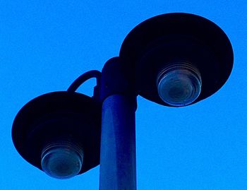 Low angle view of street light against clear blue sky