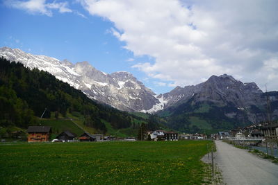 Scenic view of houses and mountains against sky