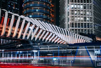 Modern bridge over railroad station in illuminated city