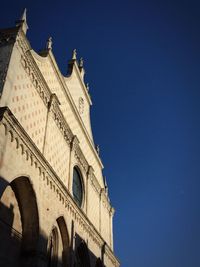Low angle view of buildings against clear blue sky