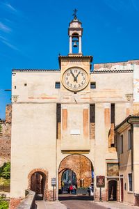 Low angle view of clock tower against blue sky