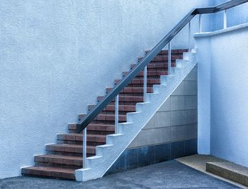 Low angle view of staircase against wall