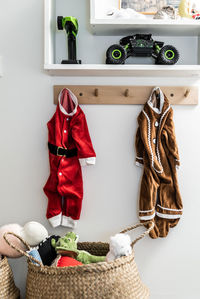 Clothes hanging over wicker basket at home