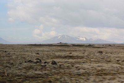 Scenic view of landscape against cloudy sky