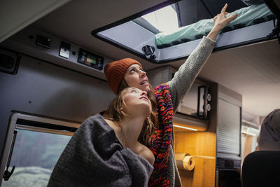 Friends looking at bed in motor home