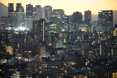 Illuminated cityscape against sky at night