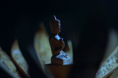 Close-up of statue against black background