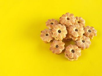 Close-up of cookies against yellow background