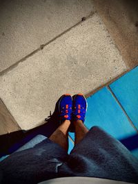 Low section of woman standing on floor in city