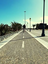 Street light on road against sky