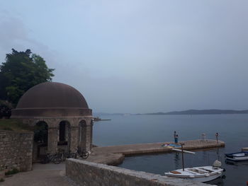 Gazebo in sea against sky
