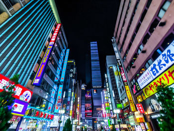 Low angle view of illuminated modern buildings in city at night