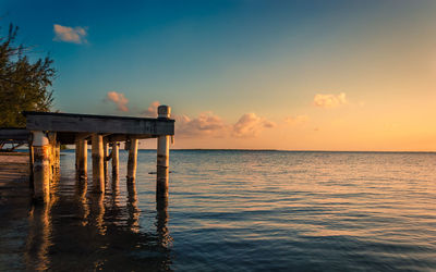 Sunset over a caribbean ocean dock