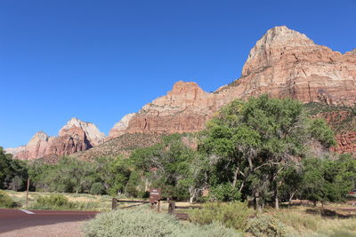 Rock formations on landscape against blue sky