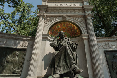 Low angle view of statue against historic building