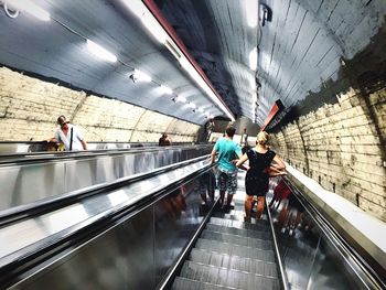 High angle view of people standing on escalator at subway station