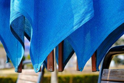 Close-up of metallic structure against blue sky