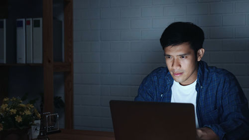 Portrait of young man using mobile phone