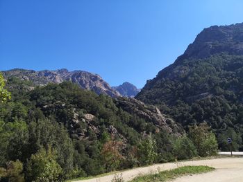 Scenic view of mountains against clear blue sky