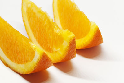 Close-up of orange fruit against white background