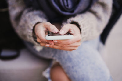 Midsection of man using mobile phone