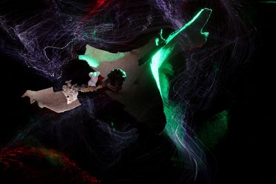 Digital composite image of woman against black background