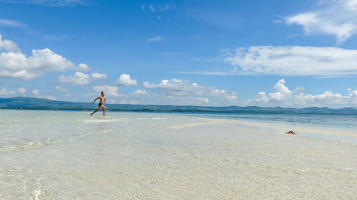 Man on beach against sky