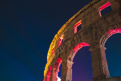 Low angle view of illuminated historical building against sky at night